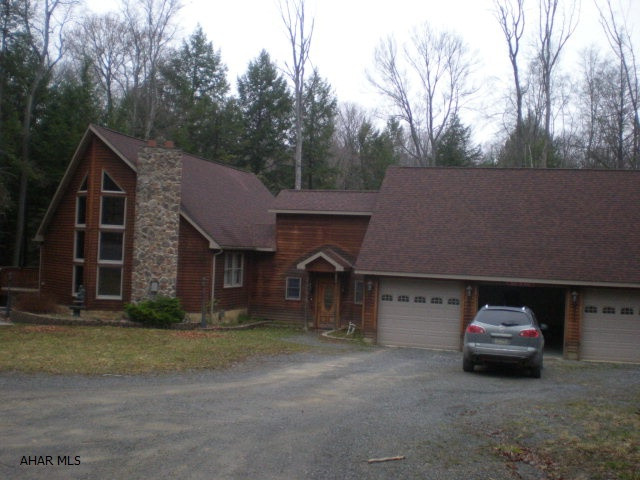 1 1/2 story cedar sided home with 3-BR, 2-BA. Large 3 car garage with family room above. 1 acre.