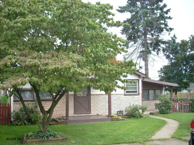 Meticulously maintained 1 story home on double, fenced lot. New laminate flooring, nice kitchen with breakfast bar, new SS appliances, 1st floor laundry, 2 bedrooms, family room and sun room. New rear deck, shed, oversized garage, off-street parking. Nice landscaping! Must see!