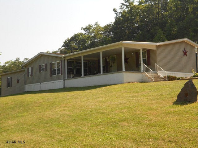 NBC school district. Great location for this triple size 1995 doublewide on 4 +/- acres. Great views from the covered front porch. Has 3 BR and 2.5 baths. Seller added a 34x32 oversized attached garage. Whole house is spacious, just waiting for you to buy!