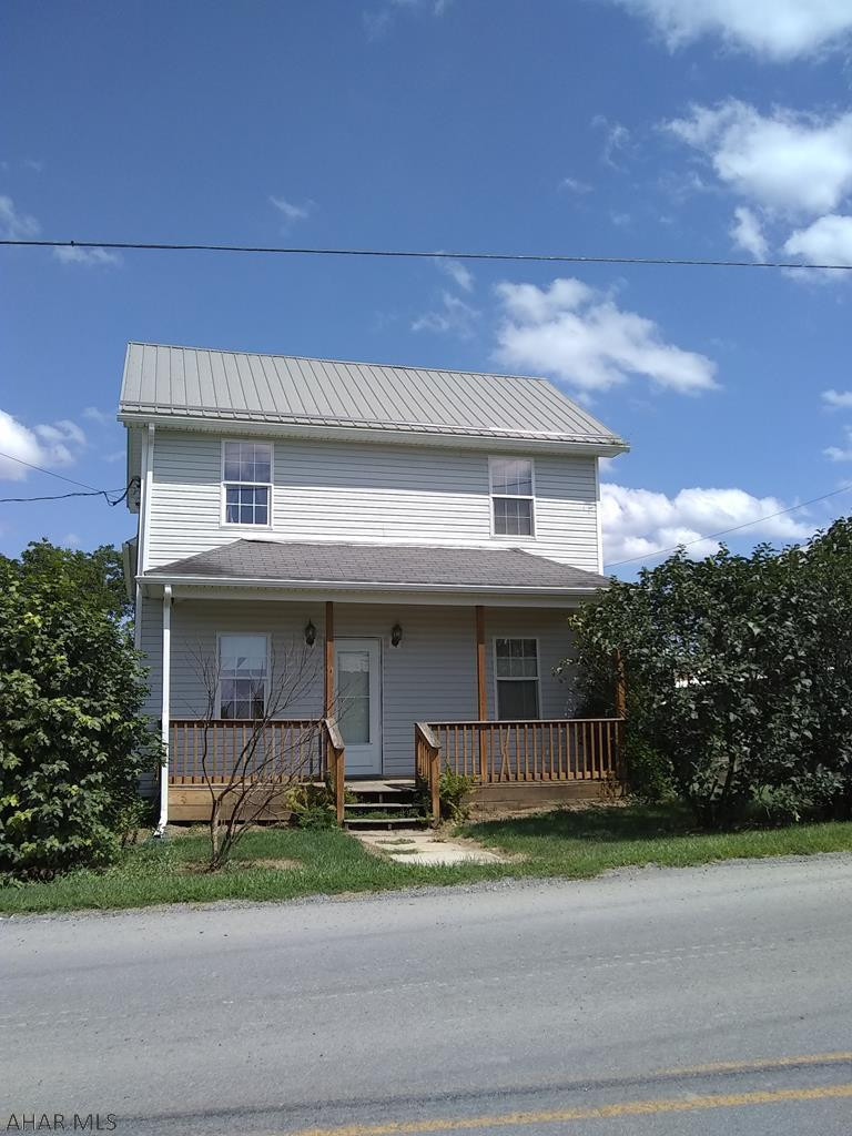 Come see this 6 bedroom charming house on over a half-acre!  It features a large yard with fruit trees, porch with view, and a 30x40 shop/garage with upper floor storage and a horse stable on the back! The house has 1.5 baths, dining room, eat-in kitchen, first-floor laundry and first-floor bedroom that could also be used as an office and 5 bedrooms upstairs.  The metal roof has years of life left and there is no shortage of parking! Great for a repair business, a bed and breakfast, or an Airbnb - Possibilities are endless! Just needs a little TLC.   Right side of property borders local farm.