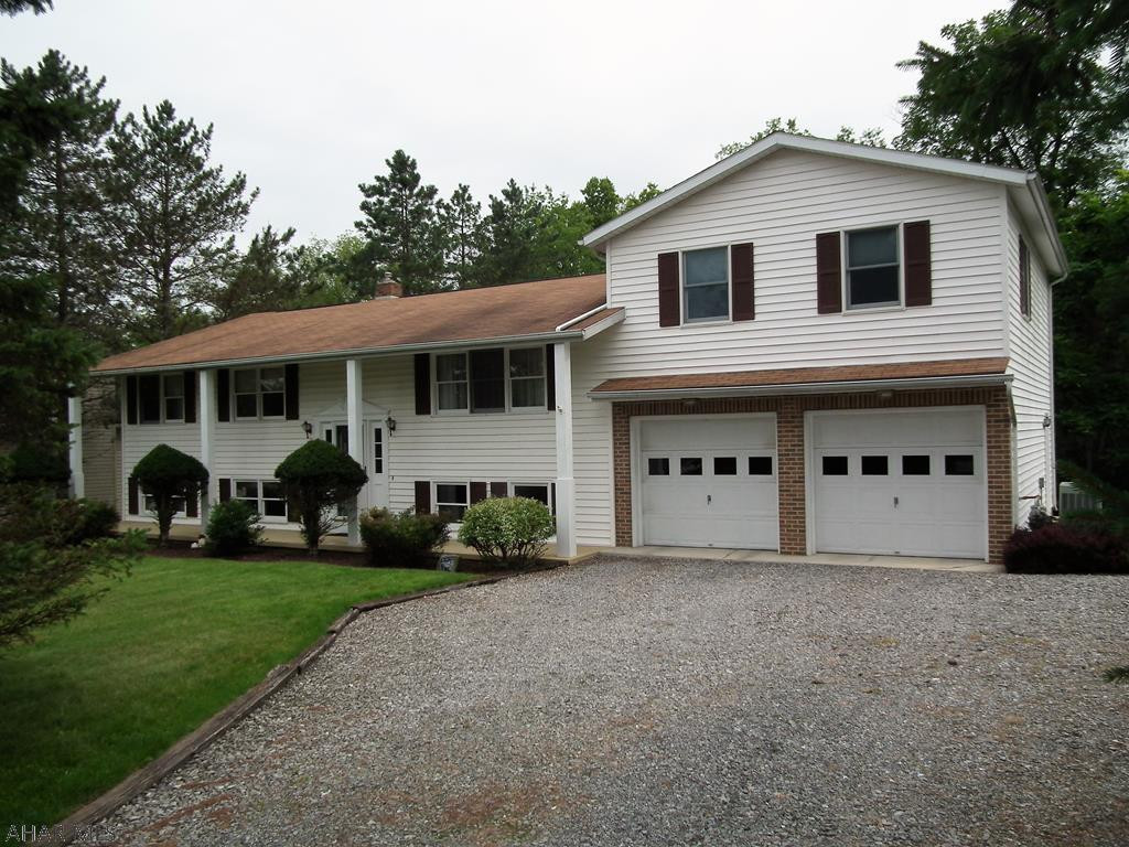 Wooded back drop in a desirable neighborhood. 4 bedroom home with 3 bathrooms, beautiful view from 2 tier deck, 2 car garage, large addition was added on for larger Master bedroom, wall closets and door leading to the top tier deck, spacious bathroom with walk in shower. Finished basement! Utilities in high usage months, gas, electric, sewer-$409. Natural gas, electric baseboard was original heating system. Central Air.