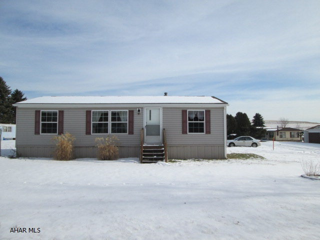 This mobile home is like new!  The kitchen features beautiful oak cabinets.  The carpet throughout the mobile home is in great condition.  The exterior has vinyl siding with a front and back porch.  The mobile home also includes a storage shed.  Lot rent is $185.00 a month.  Lot rent includes sewer, water, and garbage.  Must obey rented lot rules and regulations. Utilities have been turned off.  Could be moved to buyers own parcel of land at buyers expense.  Only minutes away from Prince Gallitzin State Park!