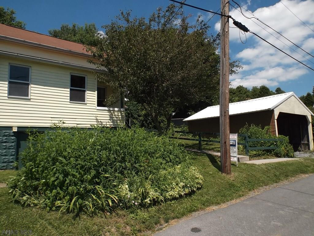 Cute one and a half story home in Gallitzin Borough located on a quiet street. Cheery, bright eat-in kitchen with appliances included.  1st floor bedroom and bath.   Mature 100x96 lot with trees and many perennials, partially fenced.  1 car detached garage. Oil forced air heat with the gas line brought to the lot for future hook up if desired by the new buyer. Newer furnace. Come take a look at this property! Would make a great hunting camp with the State Game Lands being very close by.  Property being sold "As-Is" seller will not make any repairs.