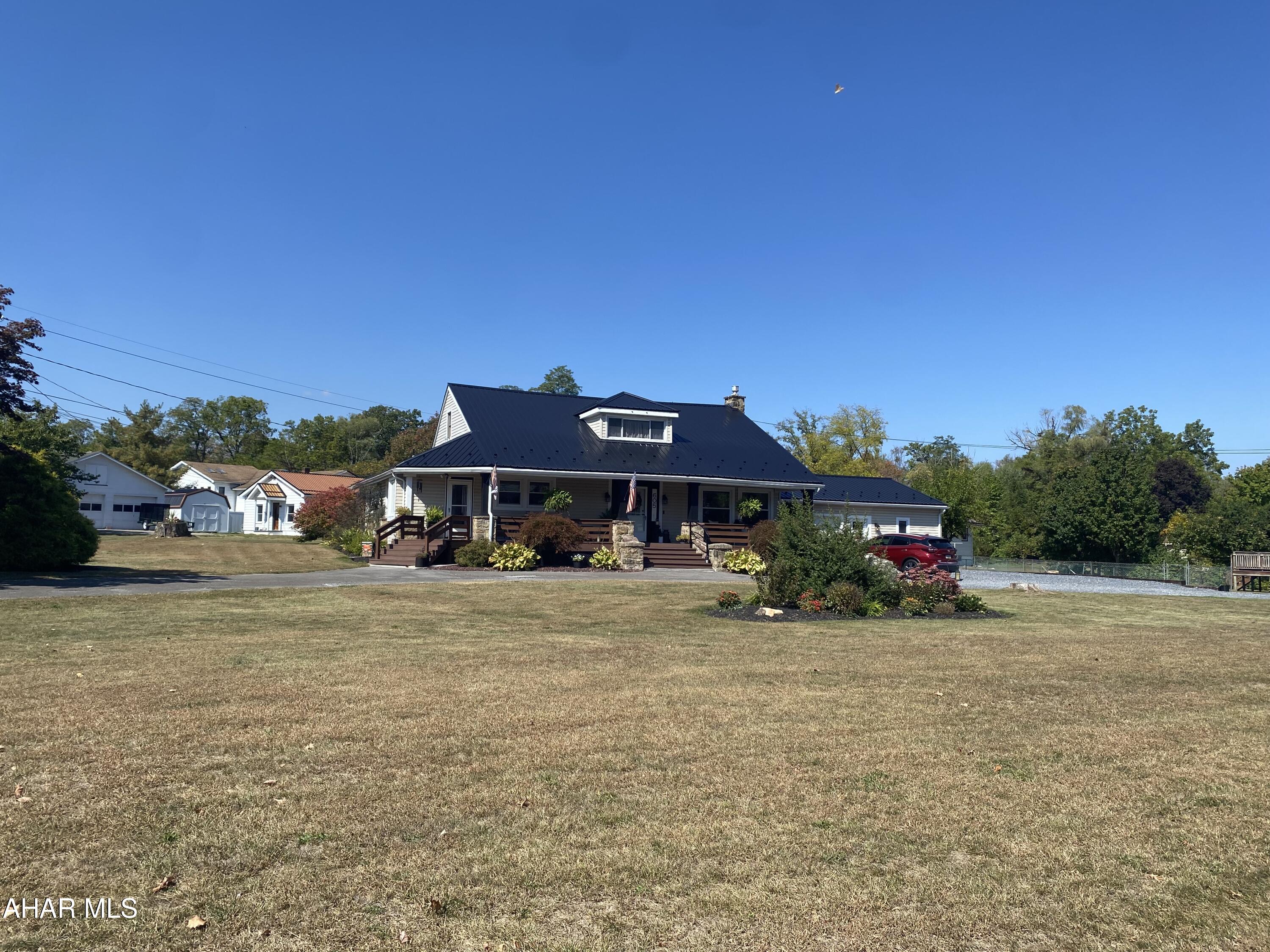 Welcome to this charming home situated on a spacious 0.7 acre corner lot in the borough of Duncansville. The property offers a large fenced-in yard, circle driveway, and plenty of parking - perfect for entertaining family and friends. Step inside to find an inviting eat-in kitchen with brand new appliances and  a convenient laundry area just off the kitchen. This home includes too many updates to list, but some substantial updates include a new metal roof, water tank, water softener, a brand new furnace, new water lines and paint throughout. Enjoy outdoor living with a large 48' covered front porch plus two additional decks through the sliding glass doors leading to the backyard. The main level features two generous bedrooms, a den or bonus room and a full bath. While the upper level boasts a third bedroom, a bonus room complete with beautiful exposed wooden beams and an additional bathroom that is a must see! A 1-car garage with an extra stall for storage, workshop or hobbies completes this property. best of all isn't not in a flood zone - giving you peace of mind. This home has space, charm and functionality all wrapped into one - don't miss the opportunity to make it yours! Sale is contingent on seller securing alternate housing.