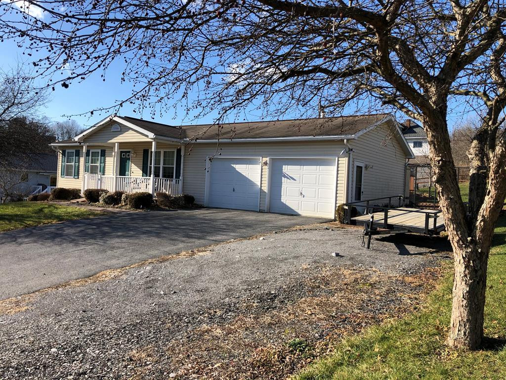 This 2 bedroom 1.75 bath ranch is perfect if you are looking for one floor living or a great starter home.  Eat in kitchen includes all appliances.  Very clean with laminate flooring throughout living and bedrooms. Large spacious basement has potential for an additional family room. Large two car garage.  Additional space for parking. Enjoy the porch swing in the evenings, or cool off in the pool in the summer. Close to Norfolk Southern!  Call today!