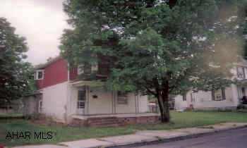 Two-Story tha needs work, but has potential. Front and rear porches. Back yard with garden space.