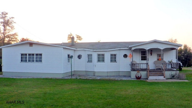 2.2 Acres, Gallitzin, Tunnelhill Street, converted mobile home with 2 bedroom, extended living room, dining area, eat-in kitchen with custom hand crafted cabinets, office and hall laundry. Addition includes a large master bedroom, sitting room with wood burner, covered front porch, attached 1-car garage, and updated electric. Included all appliances, metal shed, garden space, detached 27 x 45 garage with new metal roof, could house a tractor trailer....$79900