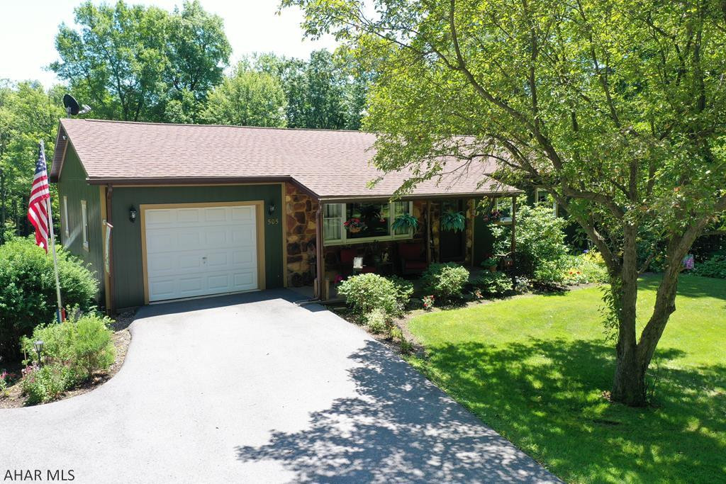 This updated raised ranch home is a rare find, situated on almost one and a half secluded acres and surrounded by woods  The home offers plenty of privacy while remaining close to I-99 for an easy commute.  On the main level, you will find a spacious kitchen with included appliances and plenty of cabinet space, formal dining room, living room, 2 large bedrooms, and a full bath. A covered deck off the kitchen overlooks the yard which is great for entertaining guests or simply admiring the wildlife.  In the basement, you will find an additional living area, bar, wood burner, workshop area, 1/4 bath, and laundry room.  There are two garages plus a large shed as well.
