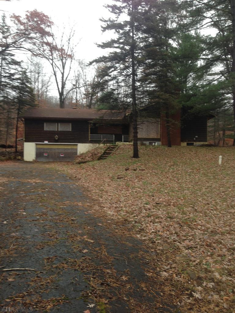 Large raised ranch with 2 car garage on 5.87 acres. Will need a lot of updating but great investment.