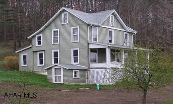 Appealing 2-story w/vinyl styling, 3BR/1BA on nearly 6 acres. Out buildings include small barn, detached garage and poultry house. Appealing 2-story with vinyl styling, 3BR/1BA on nearly 6 acres. Thermo pane windows, oil HW BB heat, large eat-in kitchen, sun porch. Being sold As-Is