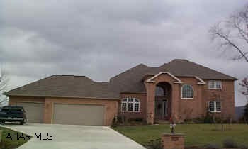 Extraordinary home with open, spacious floor plan.  All hardwood flooring on first level.  Gourmet kitchen with granite double oven, sub-zero frig., warming drawer, two sinks.  All rooms have overabundance of space and character with soft colors 9 ft. ceilings, crown molding and upgrades galore!  Tiled Florida room, den or office, formal LR and DR.  Dramatic master suite has fireplace, marble bathroom and jacuzzi and loads of closet space.  Huge finished, walkout basement rec room with 3rd fireplace, DR and full bath.  Central heating and AC with 3 zones, security system, 3 car garage.  Trex decking and fenced yard overlook large.  7742 lot with spectacular view.  See interior photos at www.carolgardiner.com