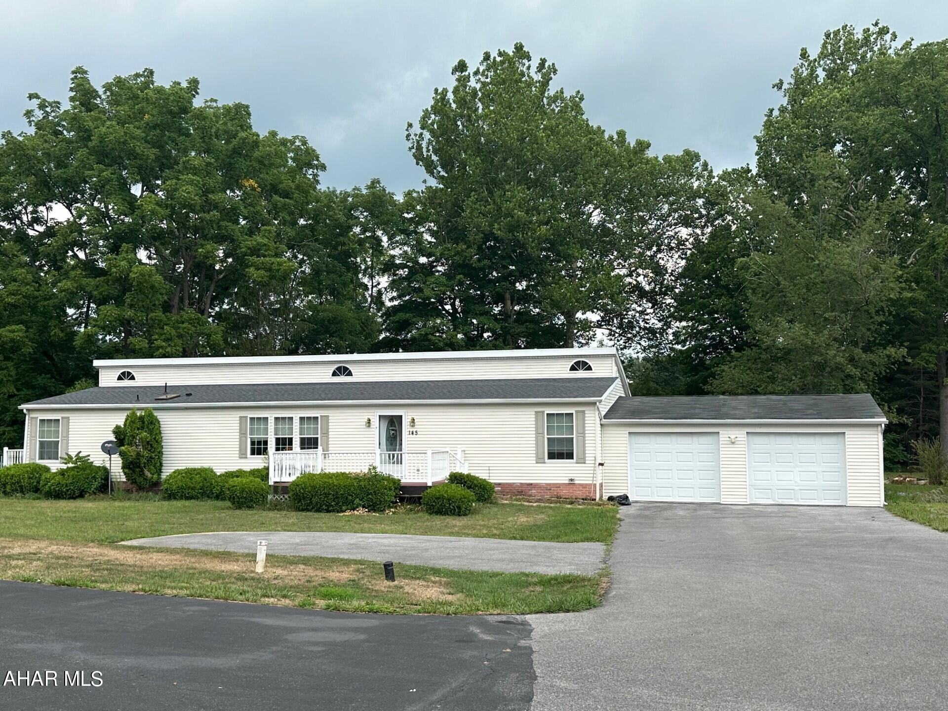 This lovely home tucked at the end of a private street has so much to offer.  Large open floor plan includes a huge eat-in kitchen with island, lots of cabinet storage and a beautiful built-in sitting nook.  Master suite boasts a walk-in closet and a large master bath.  Bonus room would be an awesome family/ game room or the perfect home office space.  The back deck is enhanced by the automatic retractable awning.  Both 2-car attached and 2-car detached garages allow for tons of storage, parking and/ or workshop space.  All this on just over an acre of ground bordered by a lovely creek.