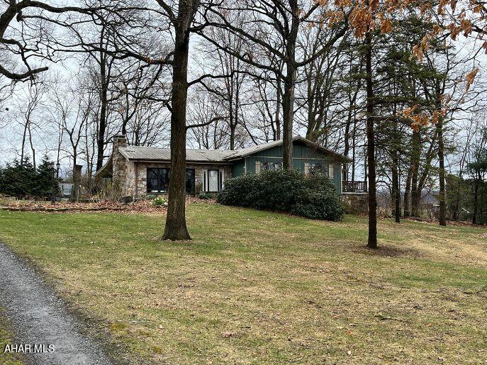 Country feel close to town! Unique, rustic home in a beautiful wooded setting. Currently 2 bedroom but easily could be 3. 2 full baths, spa room, workshop/studio/office, outbuilding for animals/dog kennel, and chicken coop make this a wonderful homestead. Spacious great room, kitchen and dining area. Lower level is set up to be a separate living space with full kitchen, bath, bedroom and living room....perfect mother in law suite or apartment.