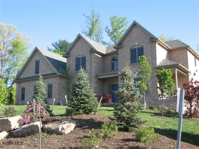 Over 4,200sf of living space in this wonderful custom built home with superior craftmanship and flowing floor plan. Beautiful hardwoods. New eat-in KT with Cherry cabinetry, wall oven and warming drawer with gorgeous granite countertops and serving area off of the formal dining room. The sitting/LR has its own private covered side porch and the FR houses a beautiful black granite fireplace. A 3season room overlooks the rear yard. The 2nd fl with its large open hallway features 4BR including a great master suite with garden jacuzzi tub and 2 huge walk-in closets. Finished lower level has rec room, office and separate entrance. Wine lovers will adore the custom built wine cellar off of the FR. This custom home, built by Metz Biilders, is situated on a lovely .77ac private wooded lot