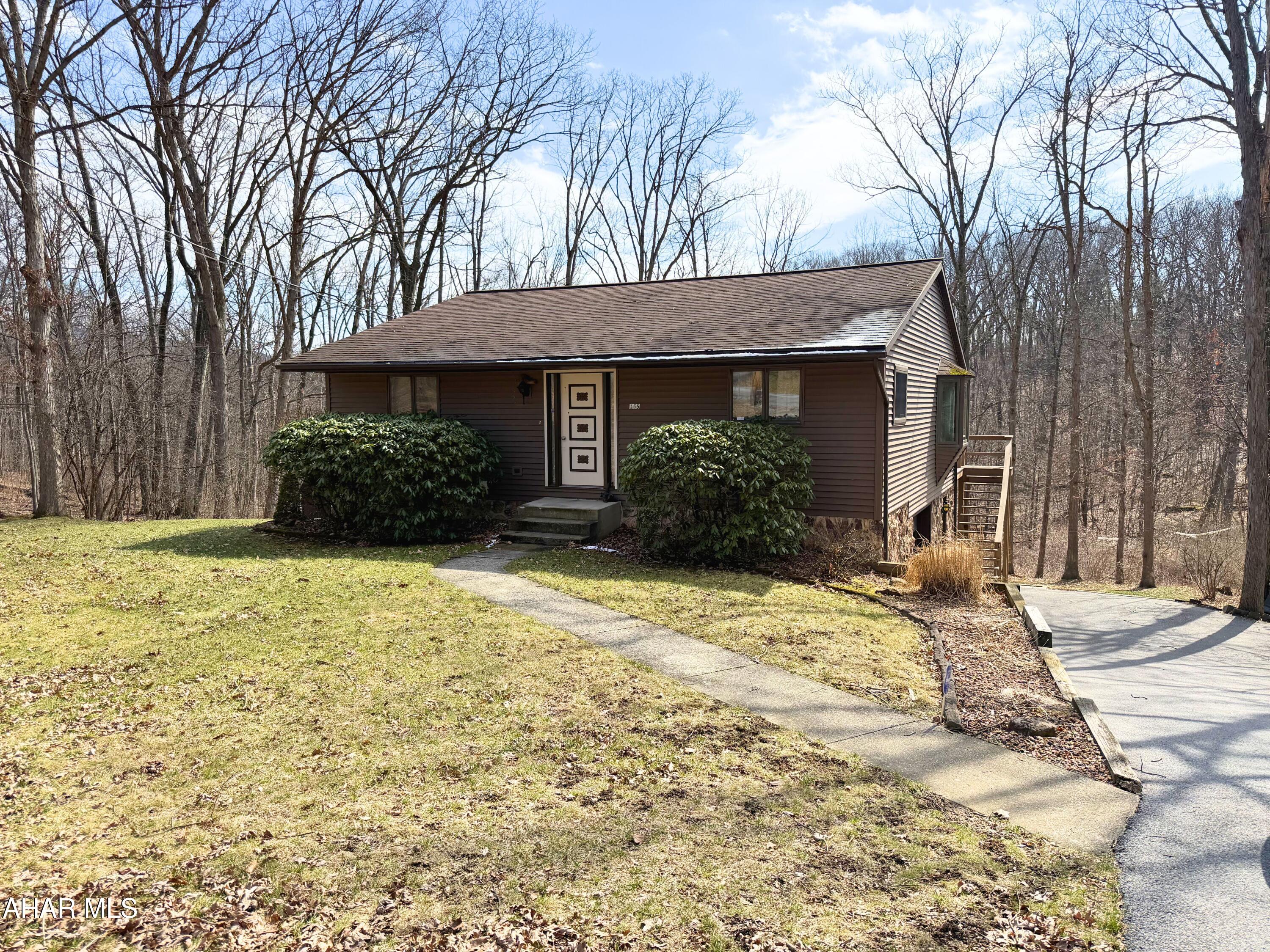 This charming 2-bedroom, 2-bath home offers the perfect opportunity to create a space that truly reflects your style and needs. With a versatile bonus area downstairs, you have extra room to design a home office, playroom, or guest space. The attached garage and paved driveway add convenience and ease of access. Sitting on just over an acre, the property provides plenty of outdoor space to enjoy or expand. Whether you're looking to personalize the interiors or take advantage of the spacious lot, this home is a fantastic blank canvas ready for your unique touch.