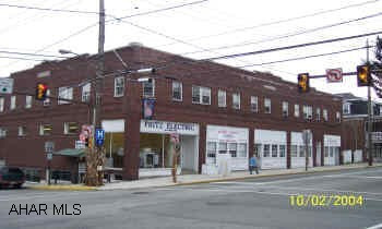 brick commercial building with large office space and corner show room.  7 apartments with downtown location. and 12 off street parking places