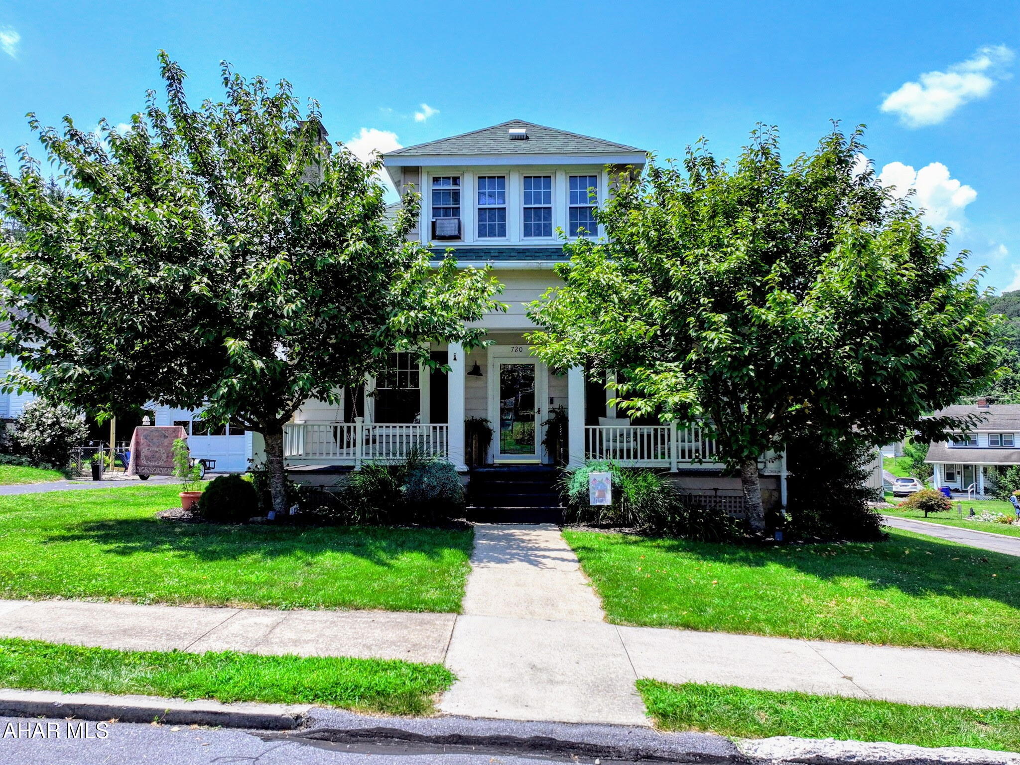 Step into timeless charm with this beautifully maintained 4-bedroom, 2-bath Craftsman-style home located in the heart of Historic Bedford, PA. Rich with character, this home features original hardwood floors, a stunning stone fireplace, and classic woodwork throughout. Enjoy morning coffee on the inviting covered front porch, and make the most of the fenced backyard complete with a children's play set—perfect for outdoor fun. The finished basement includes a full bath, spacious family room, and a dedicated workout room, with ample storage throughout the home. A detached 2-car garage adds even more convenience. Just a short walk to the scenic Bedford Heritage Trail, this home offers both charm and accessibility in a coveted location.