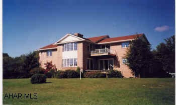 Gracious front gabled 2 story brick on hilltop with panoramic view, and professional landscaping oil, coal, wood furnace, 2 heat pumps, central air, central vac., 2 view decks, patio,