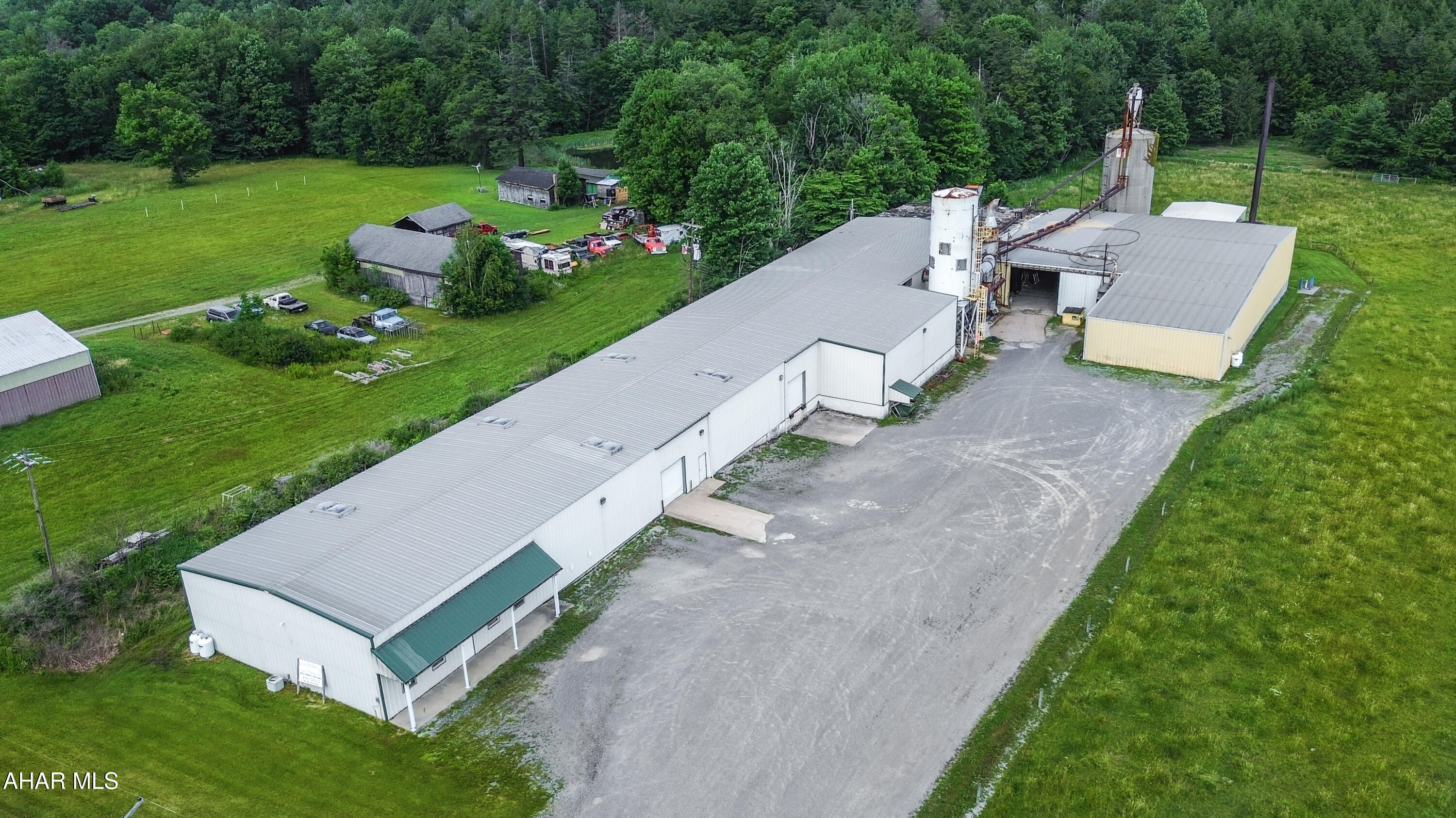 Approximately 24,000 square feet of warehouse and industrial space is now available in a highly accessible location along New Germany Road in Croyle Township, offering quick access to U.S. Route 219 N for convenient regional transportation and distribution. The primary building, constructed in 2000, encompasses approximately 16,000 square feet and features a welcoming office/showroom area, four restrooms, multiple storage rooms, and both heated and unheated warehouse space. The main warehouse boasts approximately 19-foot ceiling heights, providing excellent flexibility for manufacturing, warehousing, fabrication, or distribution operations, and includes a loading dock for efficient shipping and receiving. A second warehouse building offers approximately 6,785 square feet of additional heated industrial space with Reznor propane heaters, providing ample room for expansion, storage, or supplemental operations. Also included is an approximately 1,300-square-foot outbuilding, covered storage areas, and additional land with room for future expansion. The property is serviced by 240-volt, three-phase electric, public water, and public sewer, making it well-equipped for a variety of industrial and commercial uses. Existing equipment and dust collection systems will be removed prior to closing unless a purchaser has interest in acquiring them as part of the sale. Contact the listing agent today to schedule a private tour or to request additional information.