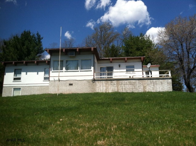 Looking for peace and quiet or a hunters and fisherman's delight?  This 3 bedroom, 1 bath home with integral garage is on 15 acres with beautiful views, a fishing stream and borders state game lands!  The property includes fruit trees, blackberry thornless bushes, woods and tillable acreage.  Conveniently located just off of I-70 and close to the PA turnpike.