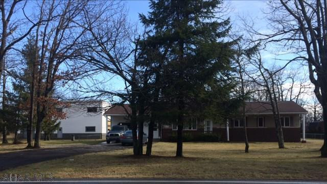 GREAT RESIDENTIAL AND/OR COMMERCIAL!  1.2 ac.Walk to State Game Lands! Only 5 mi from Penn State Altoona Campus, UPMC Altoona Hospital or downtown Altoona!  Less than 15 min to Glendale Lake! Sprawling 4 bed 2 bath ranch has a large 2 tier deck and level fenced yard. Attached 1+ car PLUS detached 6000 sq ft 2 story garage (on separate deeded lot) with high doors on 3 sides allow great auto and toy storage, business, or horse barn! Garage has a lift, bathroom and 2 offices. Home has newer wood burner, efficient heat pump/central air, 2 fireplaces, new water heater, Jacuzzi tub, light and fan fixtures, carpeting.  Perfect for hunter, sportsman, car buff, business owner or family that wants to be out yet near.  Most value on house and land. Home Inspection on file. Good well and septic.