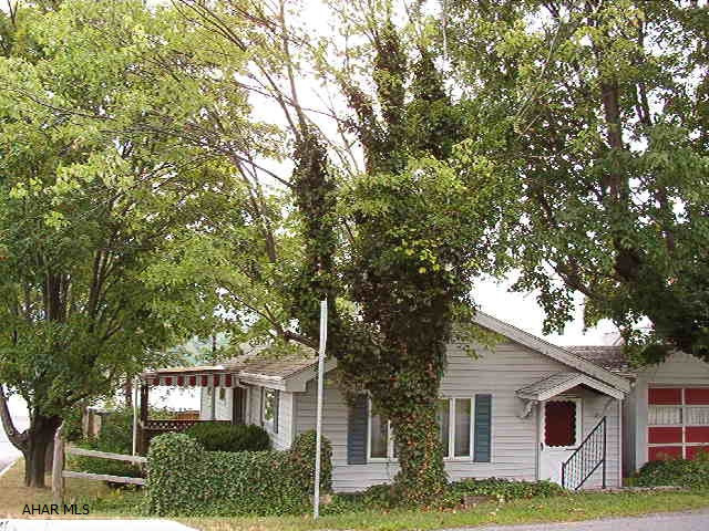 Charming 1 Bedroom home with detached 1 Car Garage and Fenced Corner Lot.  Convenient location.