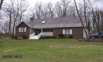 Stunning 3-4 Bedrooms/2.5 Bath 2 Story on Scenic Knoll Drive. This home is filled with pleasant surprises such as stained glass windows, hand crafted scenic panel in stair railing, jacuzzi bath tub on second floor,window seat, balcony and built-in bookcase in second floor bedroom, master bedroomwith sittng room that includes a vanity area, living room that has woodburning fireplace with hot air circulator and french doors that lead to 10x20 deck and hot tub. Basement is finished into a gorgeous bar/family room with cedarpaneling, propane.