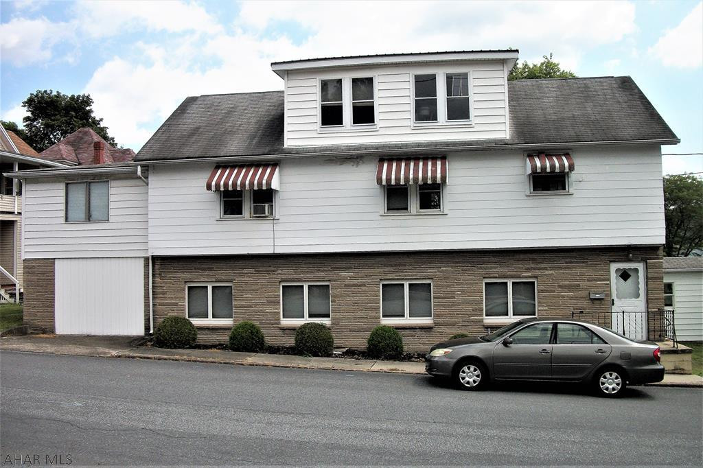 This well-kept house on a large lot can be used as a single-family residence with a mother-in-law suite or as a multi-family unit. The main level has radiant floor heat, a spacious living room with a wood fireplace insert, a kitchen with plenty of cabinet space and a large bedroom. The second level has oak cabinets in the kitchen, oak floors in the dining and living rooms, four bedrooms, a den with a cedar closet and oil hot water heat. The two-car detached garage can be accessed through the breezeway, which will keep you out of the elements. The lower level has a separate entry door for privacy.  Located in the Everett Borough at the east side of town, this property offers easy access to shopping, recreation, Interstate 70 and the PA Turnpike.