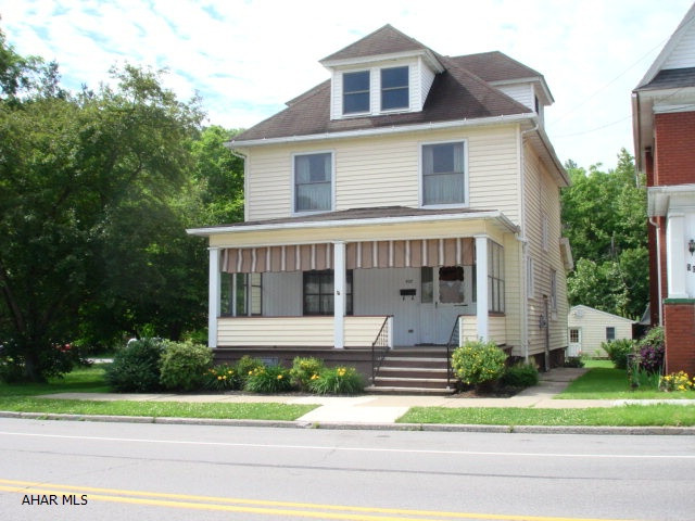 This 3 bedroom, 2 bathroom home offers large spacious rooms, natural woodwork, eat-in kitchen, lots of windows to fill the home with natural light, large bedrooms, walk-up attic that is finished and could be used as a fourth bedroom, a wonderful covered front porch, a huge covered concrete patio in the back, ample yard space, two car garage and shed.  There is an extra toilet and shower in the basement.  This welcoming home is just waiting for you!  Natural gas hot water heat.  Maintenance free exterior, great location move in ready.
