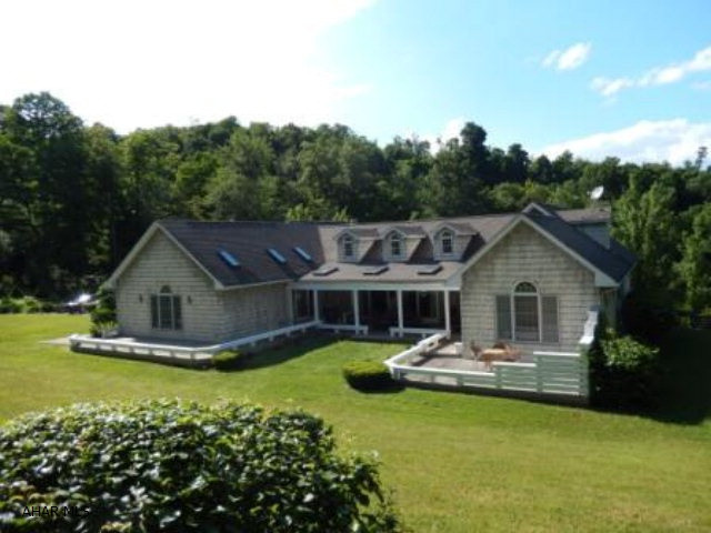Unique custom built home on 1 1/2 Acre in Logan Township. Large Spacious rooms with plenty of natural light. New hardwood floors. Valuted ceilings and skylights. This lovely setting includes pond, waterfall, garden, shed, kids play park, pavillion, fire pit and more. 2car garage and plenty of extra parking. A must see!! Air condioning is a heat pump system. Fireplaces are Propane.