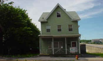 2 1/2 story frame with aluminum Good solid home, on a double lot, good mechanics, good first time buyer or investor.