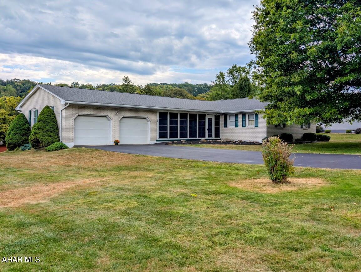Take a look at this spacious brick rancher located on a large corner lot just outside Everett in the Foor Addition. This home features a cozy pellet stove insert in the living room fireplace, four bedrooms, two baths, a craft room, along with two sunrooms to choose where you'd like to relax and enjoy kicking back a bit. You'll love the oversized attached and detached garages for keeping vehicles and toys out of the weather or to get lost in a project. The newer roof, updated windows, central air and black top driveway are added bonuses. Call to schedule your tour.