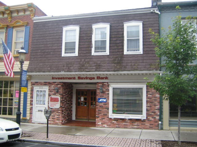 Downtown Hollidaysburg commercial building with 2nd floor apartment. Work downstairs, live upstairs and enjoy the convenience of downtown living. 1st floor consists of 1,600 sq ft office space (former bank branch -  relocated) which includes lobby, large office area, executive office suite with half bath, kitchenette, additional work areas, half bath and full walk-out basement. Very nice 2nd floor residential unit with 1 bedroom, 1 bath, living room with dining area and covered deck. Each unit has separate furnace and air conditioning units plus separate electric. Ample off street parking to rear. Broker is an affiliate of the seller.