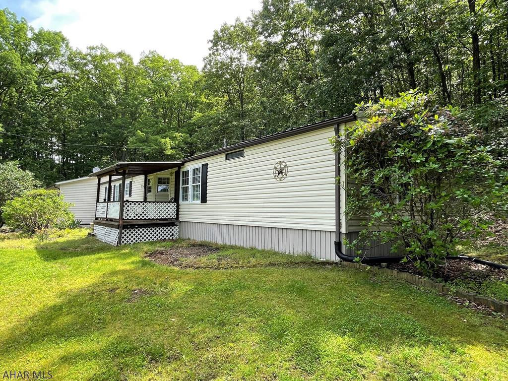 Very well maintained single-wide home resting on 2.64 acres!! This home offers a living room, kitchen, laundry room, master bedroom w/ master bath, one additional bedroom, full bath, office area and mud room. Two-car attached garage and one-car detached garage with electric. Covered front porch, private well and private septic system. Vinyl sided, thermo pane replacement windows, oil forced air heat and central air-conditioning. Beautiful country setting with beautiful views. Home is move in ready!!