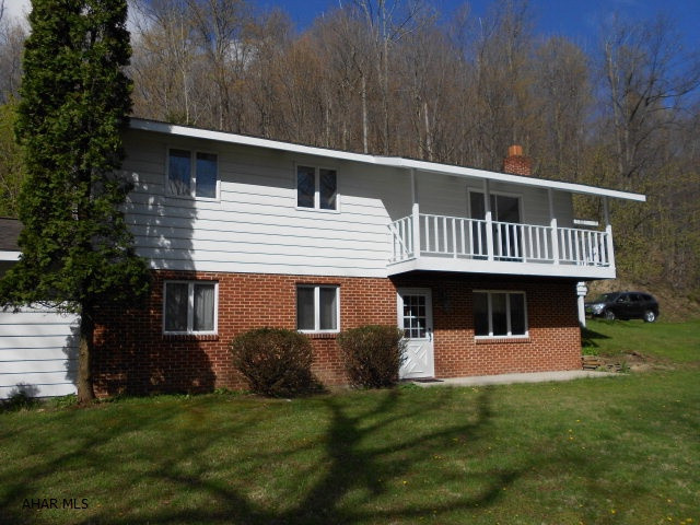 Vacation all year round in this private Bellwood Antis School District area setting on 3.87 acreage. Well maintained Ranch with customized kitchen, beautiful oak floor in Dining Room, new carpet throughout the house, freshly painted, Living Room with balcony, two patios, covered deck & sundeck.  Fresh Spring Water pond, attached two car garage and one detached garage. All Anderson Thermo Windows. Basement is fully finished with brick accent fireplace, bar area with sink and cabinets. Huge laundry room. Home provides storage space throughout the home. Oil Heat, well water, 4-ceiling fans. Skylight in 1st floor bath. WOW! YOU MUST SEE THIS PROPERTY to fully appreciate how wonderful living in this home could be.