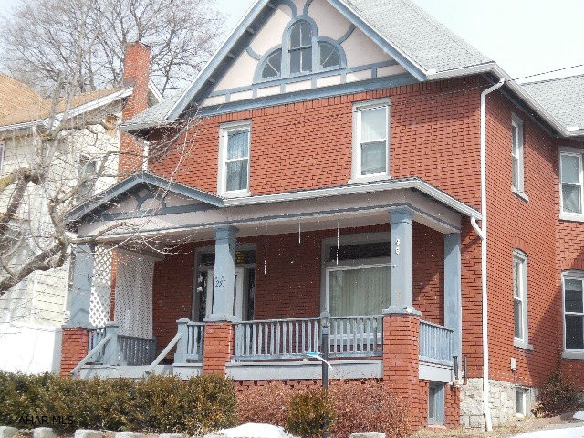 Mission Style (yr 1916) Historic home with original oak trim and wood floors; Red brick with beautiful stained glass/leaded glass windows, and lifetime replacement windows, fireplace, central air, updated kitchen & bath, 2nd floor laundry! large covered front porch, back deck(entertain all season), heated 2 car garage plus additional parking space, lots of attic and basement storage,