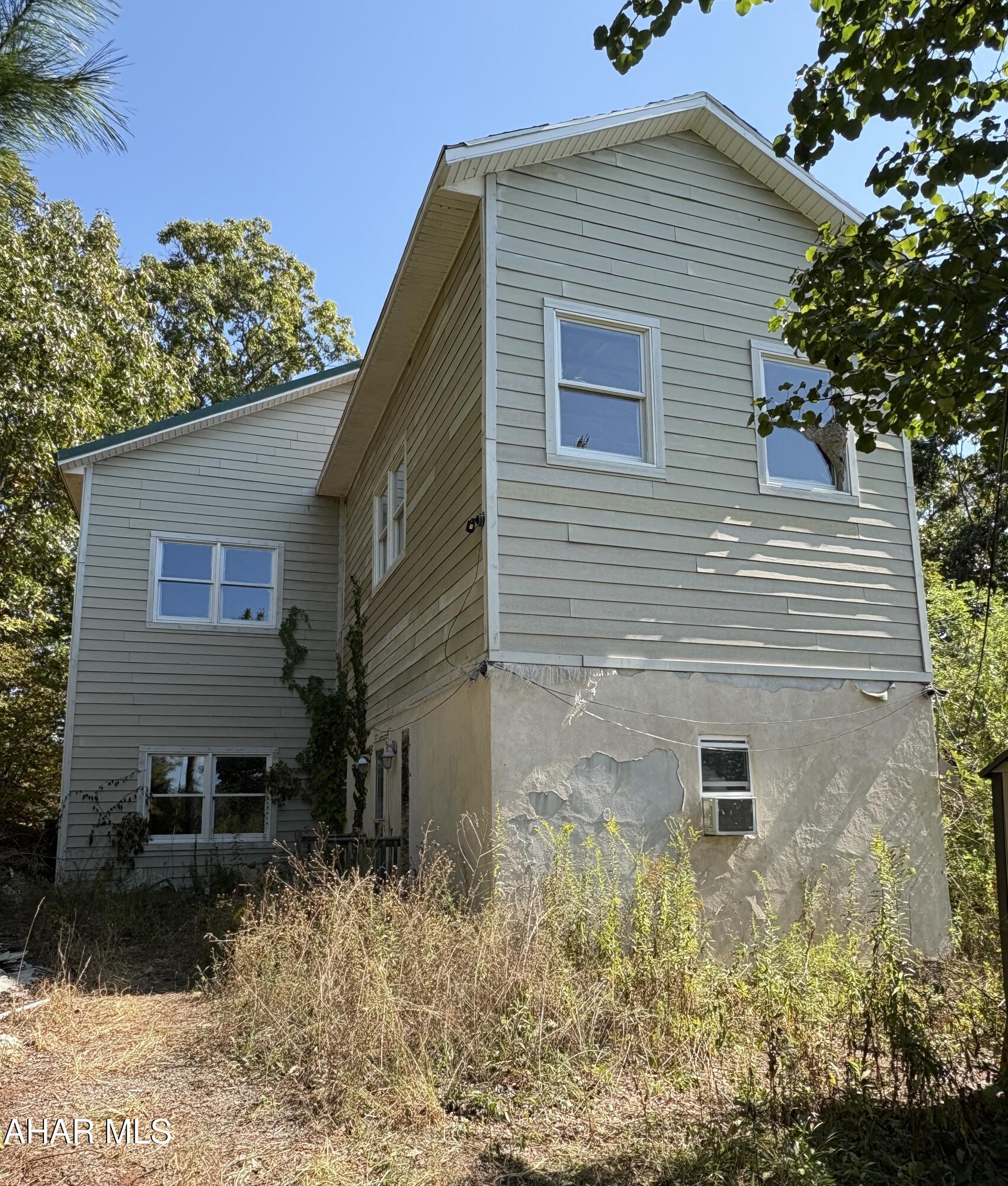 Discover the possibilities with this unique Bedford County property! Originally a cozy 240 sq ft cabin, the home now includes an expansive 3,200 sq ft unfinished addition giving you a total of over 3,400 sq ft under roof to customize as you wish. Tucked away on 20 acres, this property offers privacy, scenic surroundings, and plenty of room for your vision to come to life. The property is accessed by a township road and surrounded by woodlands, farmable land, and extends to Brush Creek. 

Utilities and finishing work will be needed, and there is currently no septic system in place. Buyers are encouraged to verify intended use with the township and appropriate authorities.

Don't miss your chance to own a slice of Bedford County countryside!