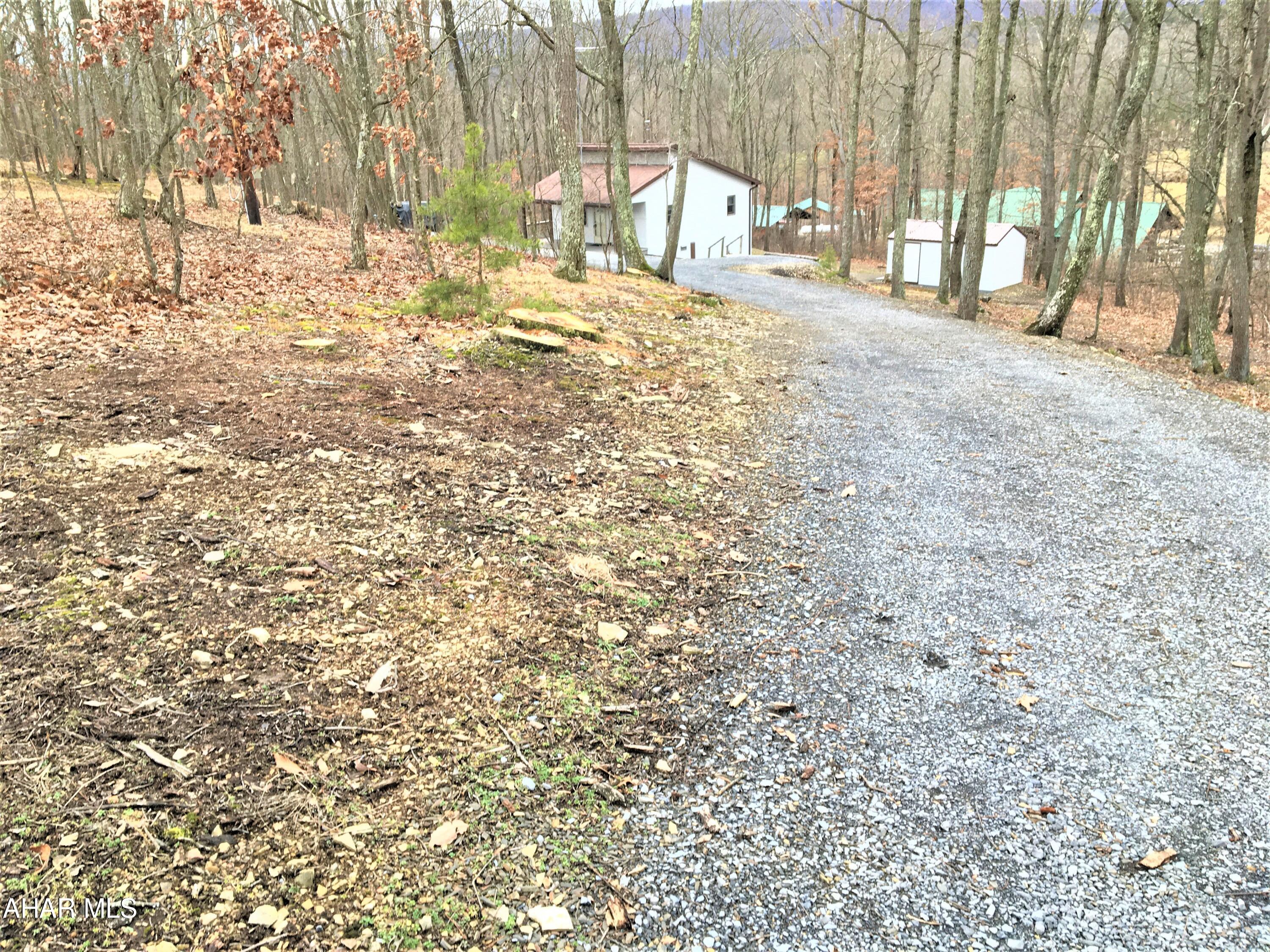 This is an immaculate , hard to find piece of property less than 1/2 mile from State Game Lands. Could be used for full time living, or second home getaway, maybe a hunting camp or an Arbnb....Has a cozy living room , dining area, kitchen, 2 bedrooms, full bath. Inviting woodstove for toasty warmth. Other heat source is propane wall heat, range/stove is also gas , along with the tankless hot water heater. Covered front porch that wraps around the side with trex flooring. Nice shed in the back. Survey of ground is with disclosures. Corners should be marked with orange , these are appx as marked by the seller. Don't miss this ready to go property!