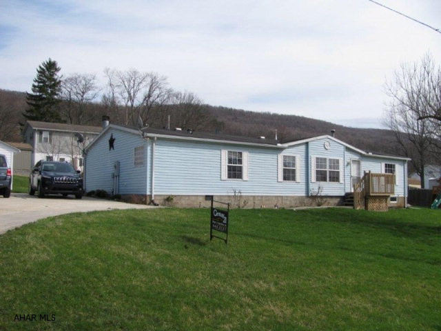 Spacious Tyrone double wide on large lot! This 26x61 home offers almost 1600 Sq. ft of one story living! LR, family room w/wood burning fireplace, EIK w/appliances, master bedroom & master bath w/ garden tub, 2 more bedrooms and another full bath! 12x60 deck to enjoy the outside space! Priced to sell at $99,900!