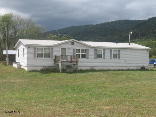 Great views and lots of wildlife here! This very spacious 30x62 doublewide sits atop a hill for complete privacy! An open floor plan that has a large kitchen with lots of oak cabinets, island, bar area, and desk area; a family room with/stone fireplace & built-in bookcases on each side; dining room has sliding doors to 9x18 back deck; nice-sized 15x14 living room.  The Master Bedroom is 15x15 with his/her closets and bath w/whirlpool tub, two vanities, & linen pantry. 2nd bedroom is 15x14 plus another bedroom and full family bath. There's a utility room w/laundry on the main level. 16x24 pavilion in back. New roof in May, 2011. New hot water heater. Centrally located between State College, Altoona & Huntingdon. 30 minutes from Lake Raystown. Great home for those who love the outdoor lovers