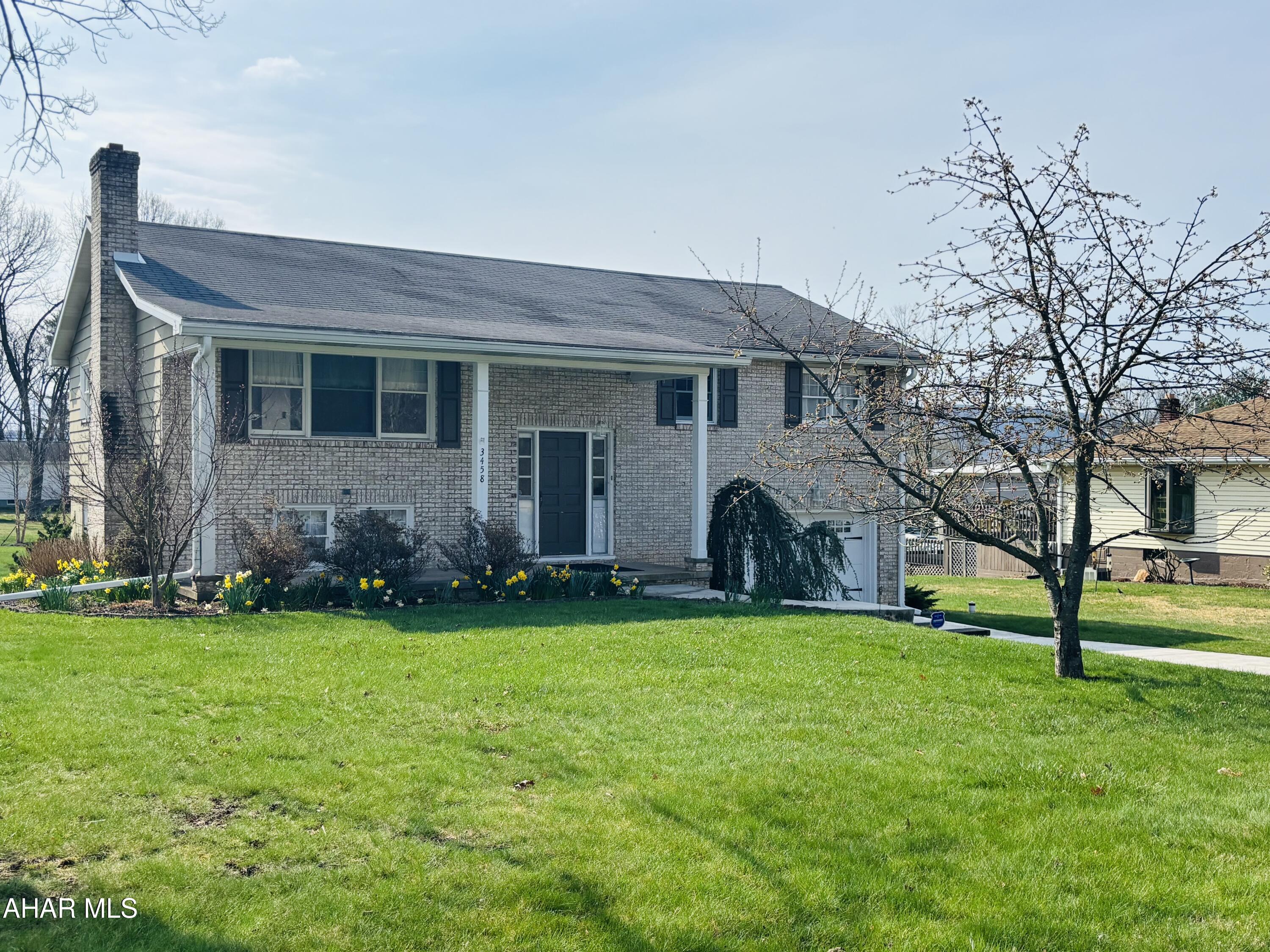 Charming new listing nestled in Frankstown Township, Hollidaysburg,
where modern comforts meet community convenience. This bi-level home features three bedrooms and two full bathrooms, making it perfect for both families and those who appreciate extra space.
Step inside to find a beautifully remodeled kitchen complete with
sleek stainless steel appliances, an abundance of cabinetry with the
soft close feature... ready for you to whip up gourmet meals. The first floor offers new, neutral paint, creating a fresh and inviting atmosphere that will make decorating a breeze. Delight in the warmth underfoot with polished hardwood floors that extend through the main areas and bedrooms, adding a layer of elegance and durability. The
full bathroom is updated with a neutral tone. The real gem might just be the cozy family room located in the basement. Recently outfitted with new carpet and has a wood-burning fireplace, it's the ideal spot for relaxing winter evenings or
hosting friends and family. Outside, your own slice of green awaits in the spacious backyard, perfect for barbecues, gardening, or simply soaking up the sun. This home also features a one car attached garage, concrete driveway,
updated garage door and retaining wall with attractive landscaping. This house is currently in full spring bloom! 3458 Glendale Road, placed in the HASD, combines everyday convenience
with modern upgrades, making it move in ready. Discover your perfect lifestyle, where community and comfort converge!