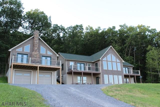 Stunning 3 bedroom 5 bath home on just over 5 acres. This 2013 custom built home has everything you need and more! Each large bedroom offers its own private bath, large closets and the 2 bedrooms on the main level have access to the balcony.  Enjoy the breath taking views from the main floor balcony while the natural sunlight shines throughout the home. Opening to the living room, the kitchen features beautiful  Craftmade cabinets,  granite coutertops, hardwood flooring, SS appliances, and a built in wine cooler. The detached 2 car garage features a 1 bedroom 1 bath suite upstairs overlooking Martinsburg. Along with a great private location, the 5.02 acres adjoins to state game lands for hunting. Call listing agent for your private tour.  PRE-APPROVAL required, please don't drive up lane.