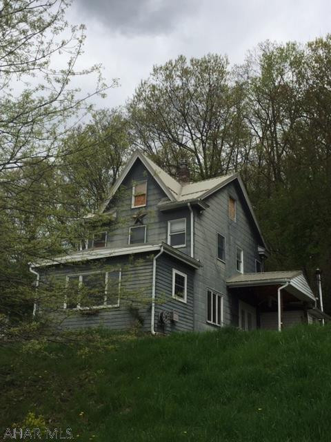 Home sits on a large lot with a ton of potential. Hardwood floors, kitchen island. Very large metal outbuilding with electricity. Metal roof. Connection to Logan township sewer is required and will be the responsibility of the buyer. Tap connection to Altoona water will be the responsibility of the buyer.