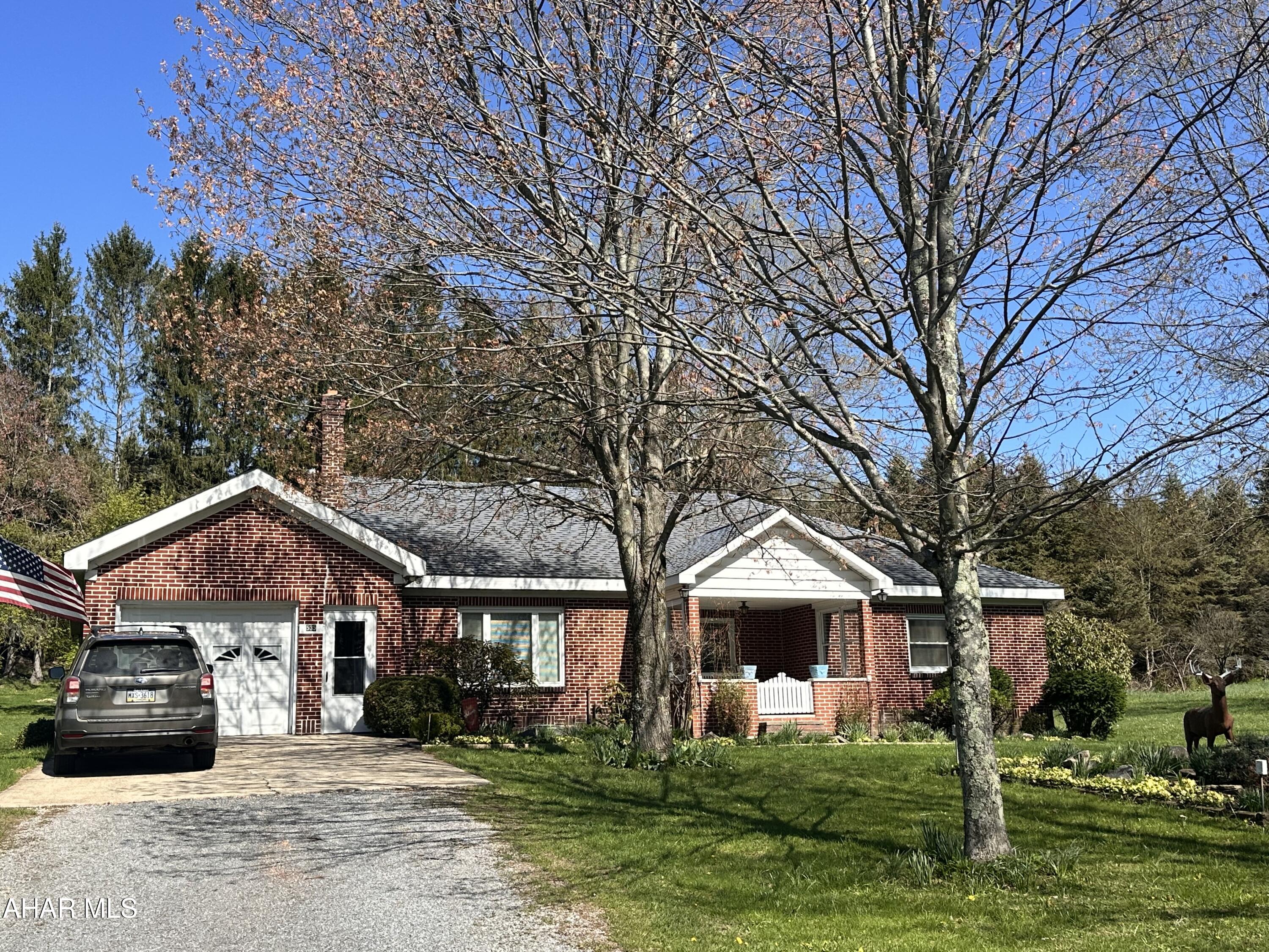 Beautiful brick ranch home on 1.4 acres.  The spacious eat in kitchen is perfect for entertaining! Enjoy your morning coffee on the rear enclosed porch with nature views. There are three spacious bedrooms and 1.5 baths, and den that could be used as a 4th bedroom.  The living room features beautiful built in bookcases and a fireplace.  Two heating sources give you an option to heat with oil or wood/coal. The walk up attic could be finished into additional living space.