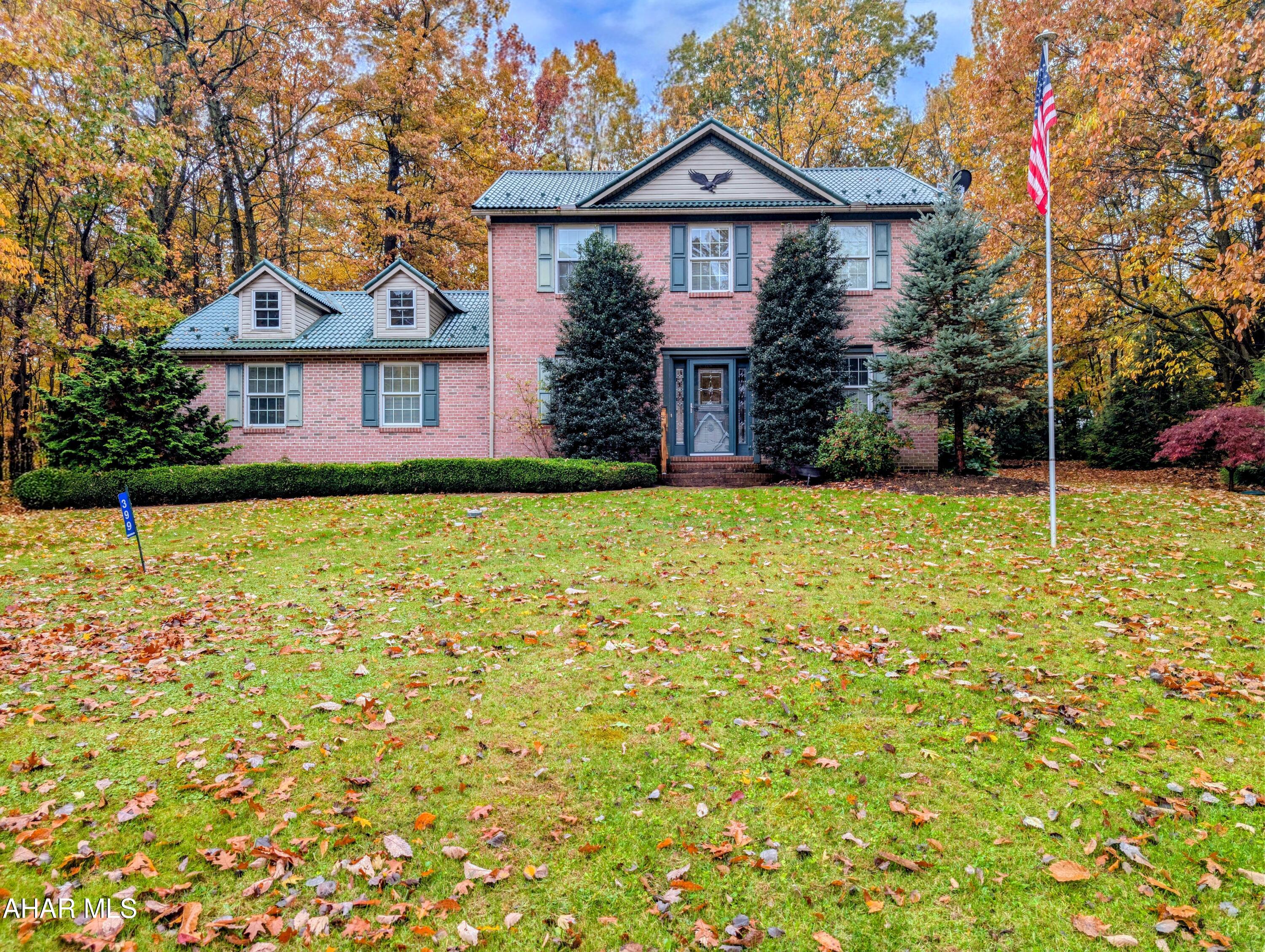 Charming 3 bedroom, 2.5 bath home with 1932 sq ft in Ridgewood Heights, in the Chestnut Ridge School District. A classic brick front, and American flag welcome you to this wonderful home.  The kitchen opens to the living area, great for everyday life and entertaining, plus there's a separate dining room for special meals. Enjoy the bright 4 season sunroom, perfect for extra living or dining space year-round. Outside, there is a brick patio with a retractable awning, ideal for relaxing or entertaining outdoors, all while overlooking a private wooded back yard. Bedrooms are on the second floor, with a roomy master with private en suite full bathroom and good closet space, plus two more bedrooms that share a full hall bath, ideal for family, guests, or a home office. Additional features include a newer metal roof, a 2 car attached garage, and a full basement with tons of storage or room to finish. This home blends classic curb appeal with a smart, family friendly layout. Give us a call today to schedule a tour and make this your new home!