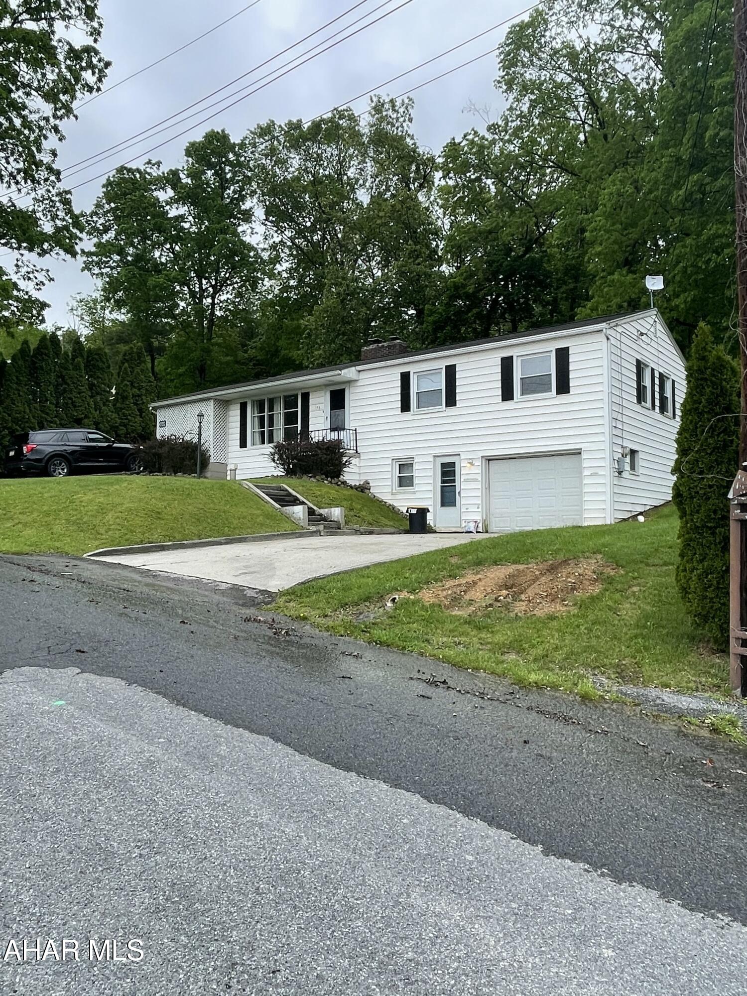 Just off Lincoln Highway, only 2 miles from corner of Pitt and Richard Street, this updated rancher is nestled in a quiet neighborhood.  The rolling terrain and mature landscaping provides plenty of privacy inside and outside.  Walk through the front door and get welcomed by a spacious family room and a crackling fire in the wood burning fireplace.  The oak floored family room leads to the dining area and nicely appointed kitchen with granite counter tops and wood cabinets.  Enjoy the view of the peaceful, forest lined backyard while doing food prep.  Retire to one of the 3 oak floored bedrooms, lighted closets, and ceiling fans.  Head down the carpeted stairs to the finished, walk out basement for game night.  The recreation area features drop ceiling, classic black and white checker board flooring and knotty pine paneling.  The full bathroom in basement makes family game night or monthly poker game a breeze.  You won't feel cramped when doing laundry in the spacious utility room with plenty of room for a work bench and tool chest. The one car garage is accessed through the recreation area and has space for a midsized vehicle and some lawn tools and machines.  Enjoy the outdoors with the 'big enough for a party' covered patio which is conveniently accessed through dining area.  The party can spill into the flat backyard for corn hole, horseshoes, wiffle ball, volleyball, etc.  Come see this house; you'll have time to make it your home and enjoy the coming summer months and then the stunning fall foliage.  Buyer to verify acreage and square footage.