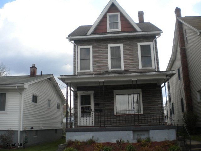 Large eat-in kitchen with laundry area and washer/dryer, formal DR, 3/4 bath in basement, finishable attic, covered front porch, 2 car detached block garage, mostly fenced back yard