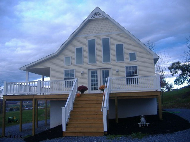 WOW WHAT A VIEW STAND ON THE  WRAP AROUND PORCH OR LOOK OUT THE LIVING ROOM WINDOWS ITS JUST BREATH TAKING...THIS HOME WAS CONSTRUCTED IN 2009/2010 AND SITS ON 1.17 ACRES..THIS HOME FEATURES 1ST FLOOR OPEN FLOOR PLAN ,HARDWOOD FLRS,2 BEDROOMS, 1 FULL BATH, KITCHEN W/ OAK CUPBOARDS AND ALL APPLIANCES, 2ND FLR LOFT IS MASTER BEDROOM WITH LARGE PORCELAIN TILE SHOWER, BASEMENT LEVEL INCLUDES A BATH, FAMILY ROOM, LAUNDRY AND A BEDROOM , A HEAT PUMP ,R-38 INSULATION IN THE CEILINGS AND R-19 IN THE WALLS...