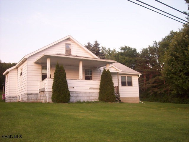 Lovely 1 1/2 story home situated on 5 acres!  Large sunken living room addition with corner propane fireplace.  Generous room sizes.  New windows throughout.  Walkup attic for storage.  Outdoor wood & coal burning furnace for low cost heating as well as oil furnace.  2 Sheds on property.  City water but also has 2 wells on the property.  Very near state game lands and still only 30 mins. from Altoona and Clearfield.