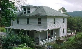 Nice farmhome with country charm. Gorgeous views of the mountains from the large covered rear deck. Custom milled wood walls in the kitchen and built in hutch. Heat is oil and also a kerosene burner-gravity fed that is great when there is a power outage. Newer windows, central air, furnace , and new well  November 2006 and other updates.  Call for complete list. Call DIANNE 329-1856.